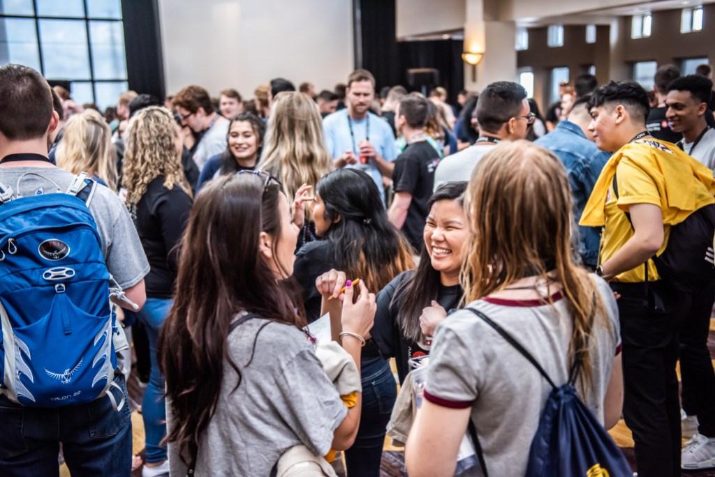 An image captured at AMA's International Collegiate Conference. It showcases hundreds of students socializing and networking with their peers.