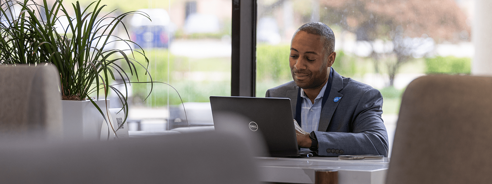 Man working at his laptop during a break at a conference